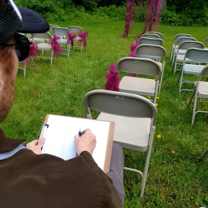 Artist drawing live at an outdoor wedding